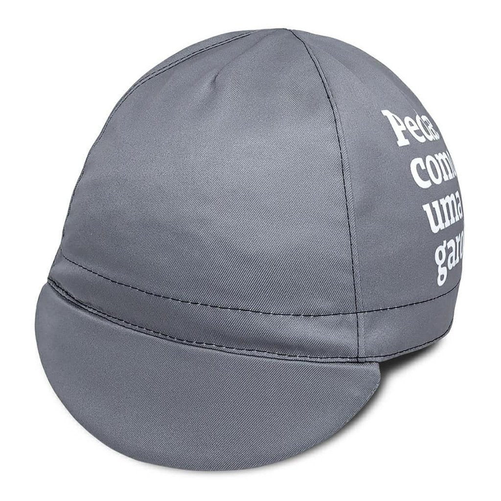 Foto colorida Cap cinza, visto de cima, ao lado esquerdo está escrito pedale com uma garota em branco. Fundo branco.